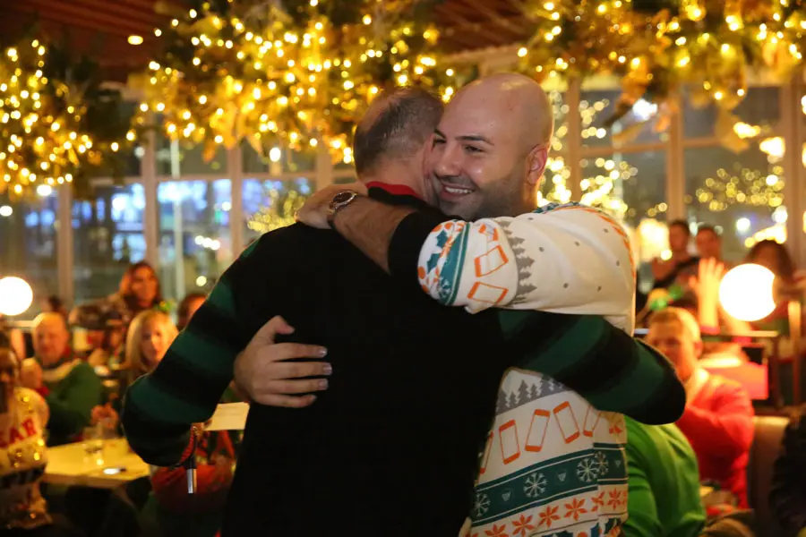 Saber giving a hug to another Wireless Vision team member